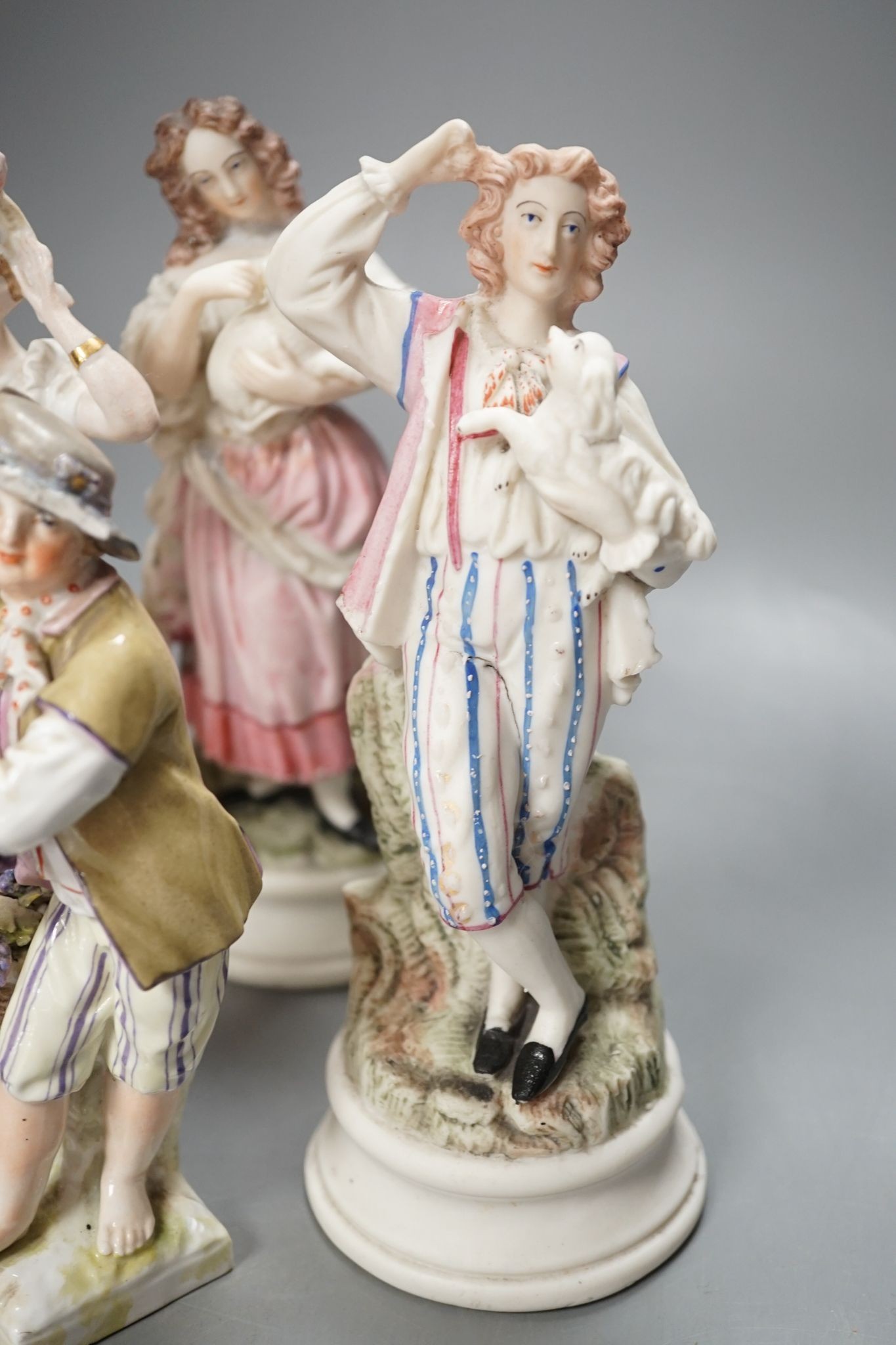 Ten French bisque figures and a Berlin figure of a grape picker, tallest 19cms high.